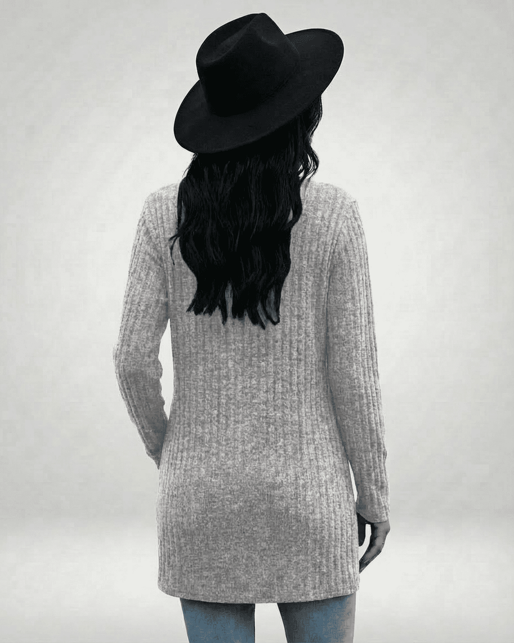 Back view of a model wearing the Luna Cardigan by Lauven, showcasing its longline design and ribbed texture.