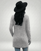Back view of a model wearing the Luna Cardigan by Lauven, showcasing its longline design and ribbed texture.