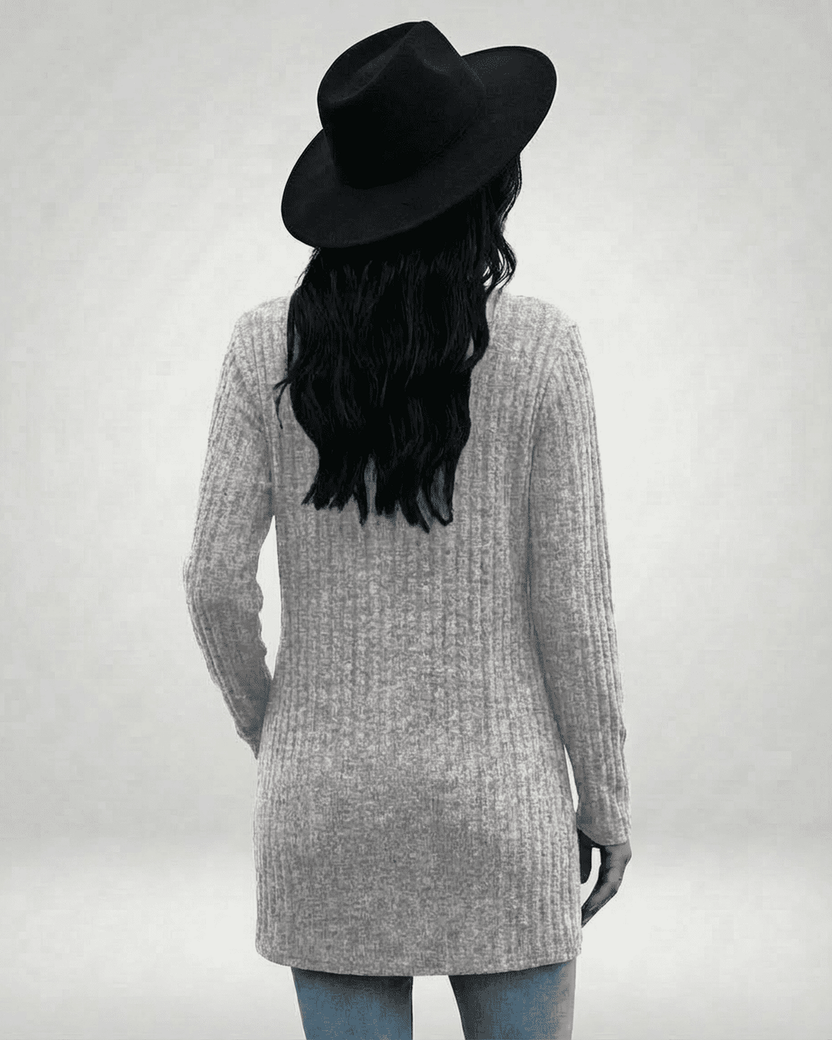 Back view of a model wearing the Luna Cardigan by Lauven, showcasing its longline design and ribbed texture.