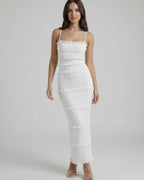 Lauven Luna Maxi Dress showcasing a sleek sheath silhouette in crisp white with spaghetti straps and textured details.