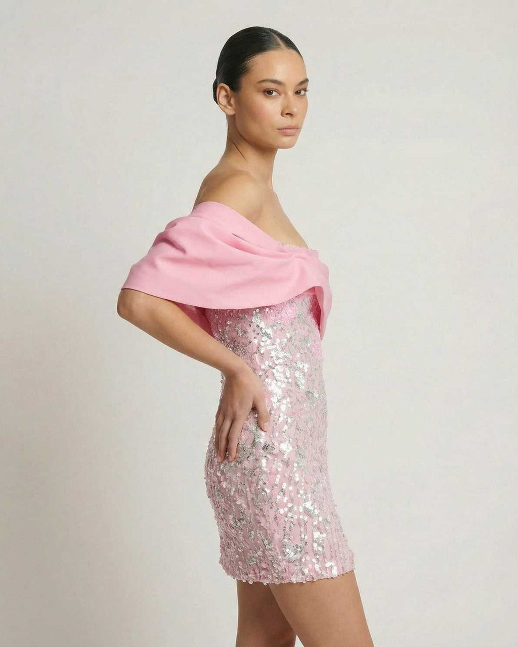Lauven Luna Mini Dress featuring pink sequins and off-the-shoulder design, perfect for a glamorous party look.