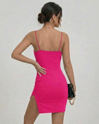 Back view of the Lauven Luna Mini Dress in vibrant pink, showcasing its sleek fit and side split.