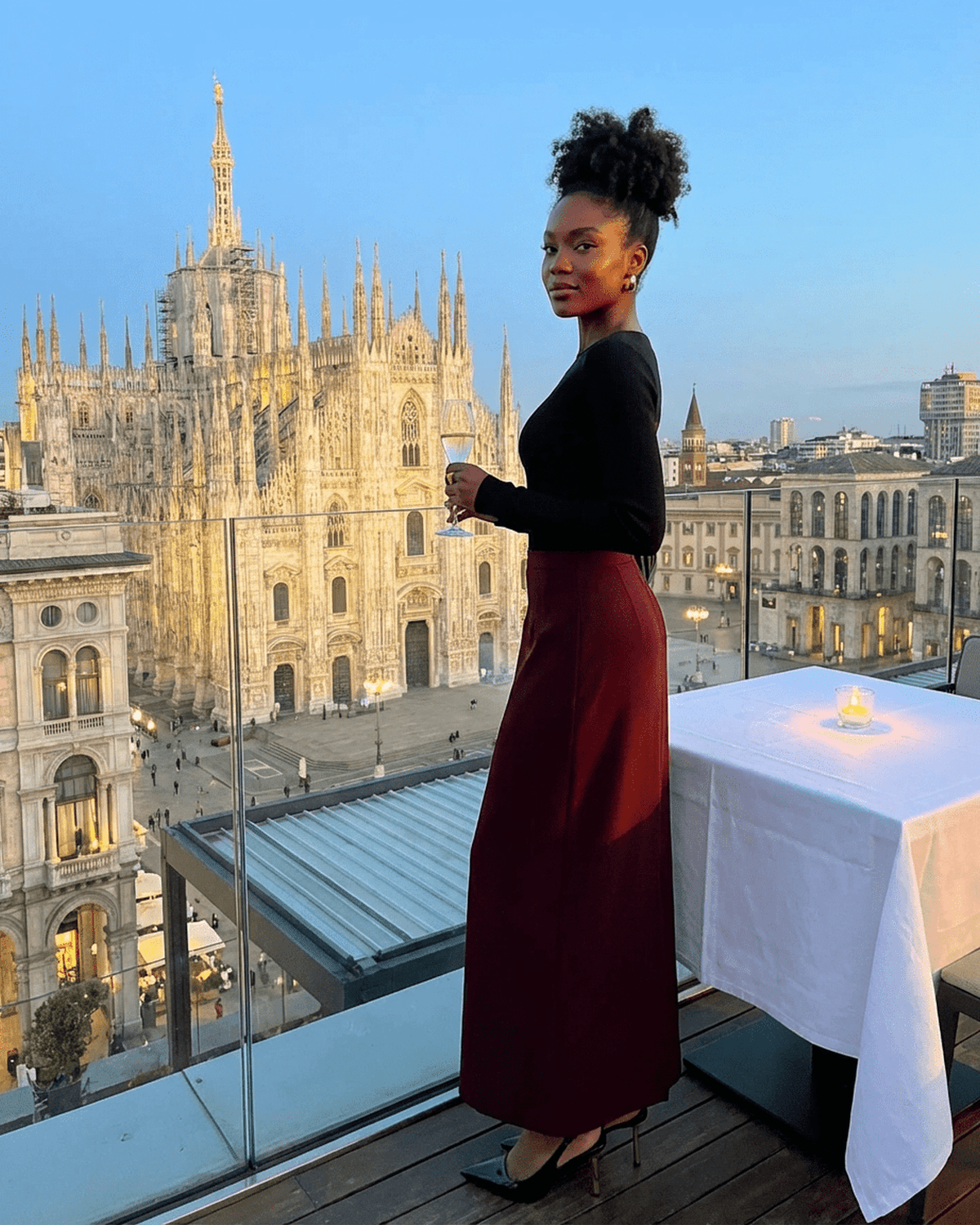 Merlot Maxi Skirt by Lauven worn by a woman with a stunning cityscape view in Milan.