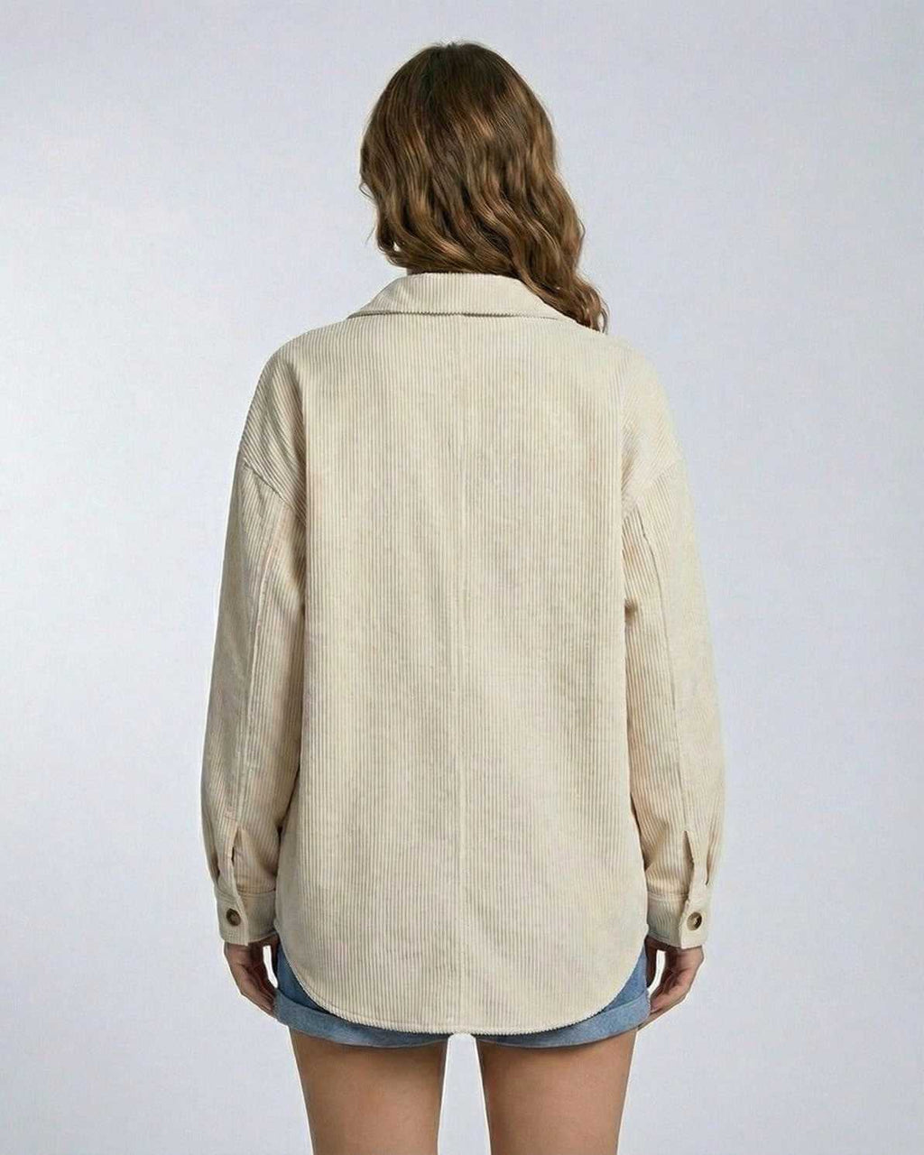 Back view of a woman wearing the Monaco Jacket by Lauven, showcasing its relaxed oversized silhouette in soft corduroy.