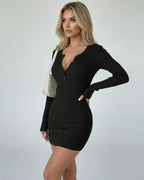Elegant model wearing Lauven Noir Mini Dress featuring a deep V-neck, long sleeves, and bodycon silhouette in black.