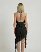 Back view of Lauven Noir Mini Dress featuring ruffle detail and asymmetrical hemline in classic black.