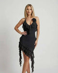 Model showcasing the Noir Mini Dress by Lauven, featuring ruffle details and an asymmetrical hemline in classic black.