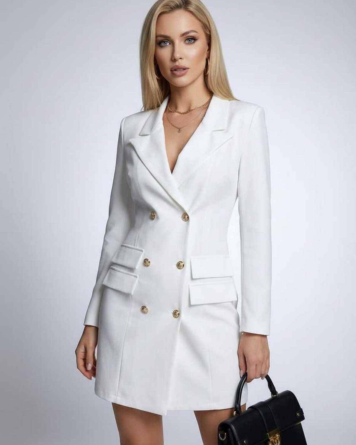Model wearing the Nova Mini Dress by Lauven, a white double-breasted blazer dress with V-neck and long sleeves.