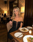 Nova Mini Dress by Lauven worn at a restaurant, showcasing an off-shoulder style and sleek design.