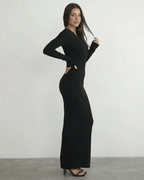 Model wearing the Nyx Maxi Dress by Lauven, a long sleeve black dress featuring an open back detail.