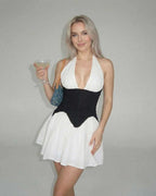 Lauven Orion Mini Dress showcases color block design with a white skirt and black corset panel, perfect for stylish occasions.