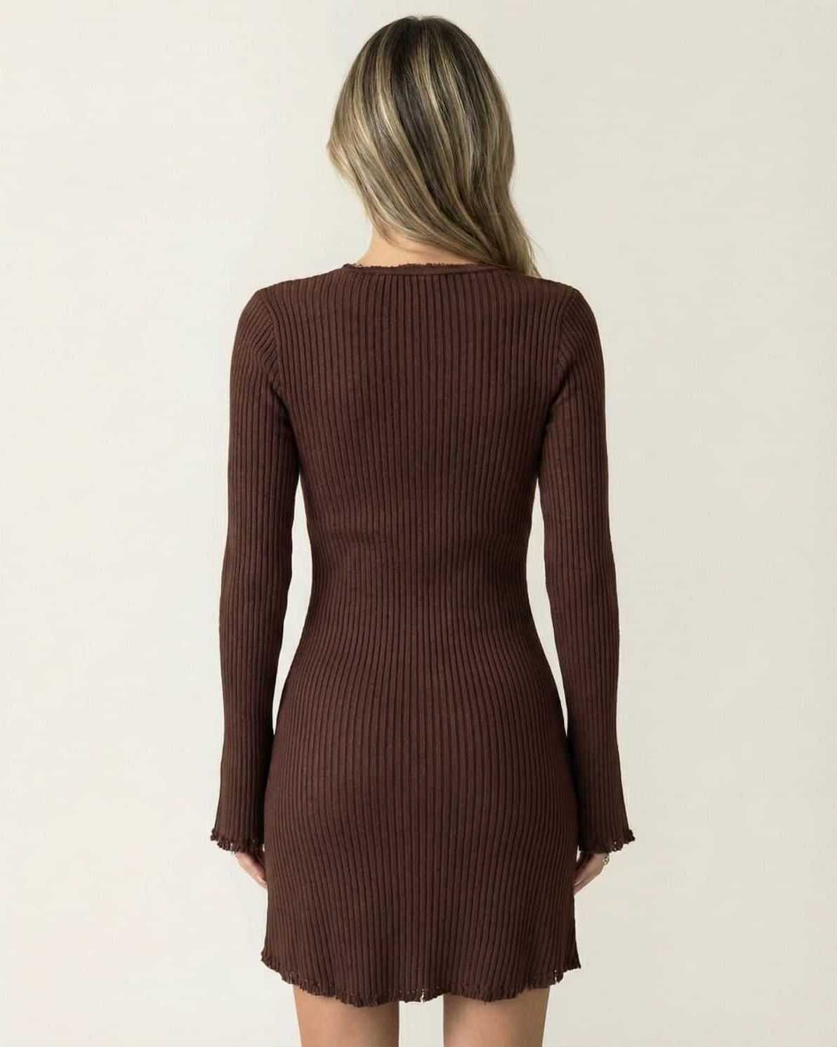 Back view of the Orion Mini Dress by Lauven, showcasing its ribbed fabric and flare sleeves in deep chocolate brown.