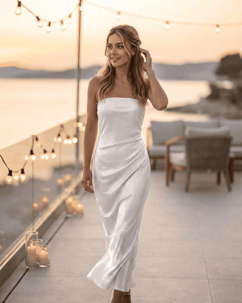 Lauven Pearl Maxi Dress showcases a strapless tube silhouette with subtle ruched texture against a sunset backdrop.