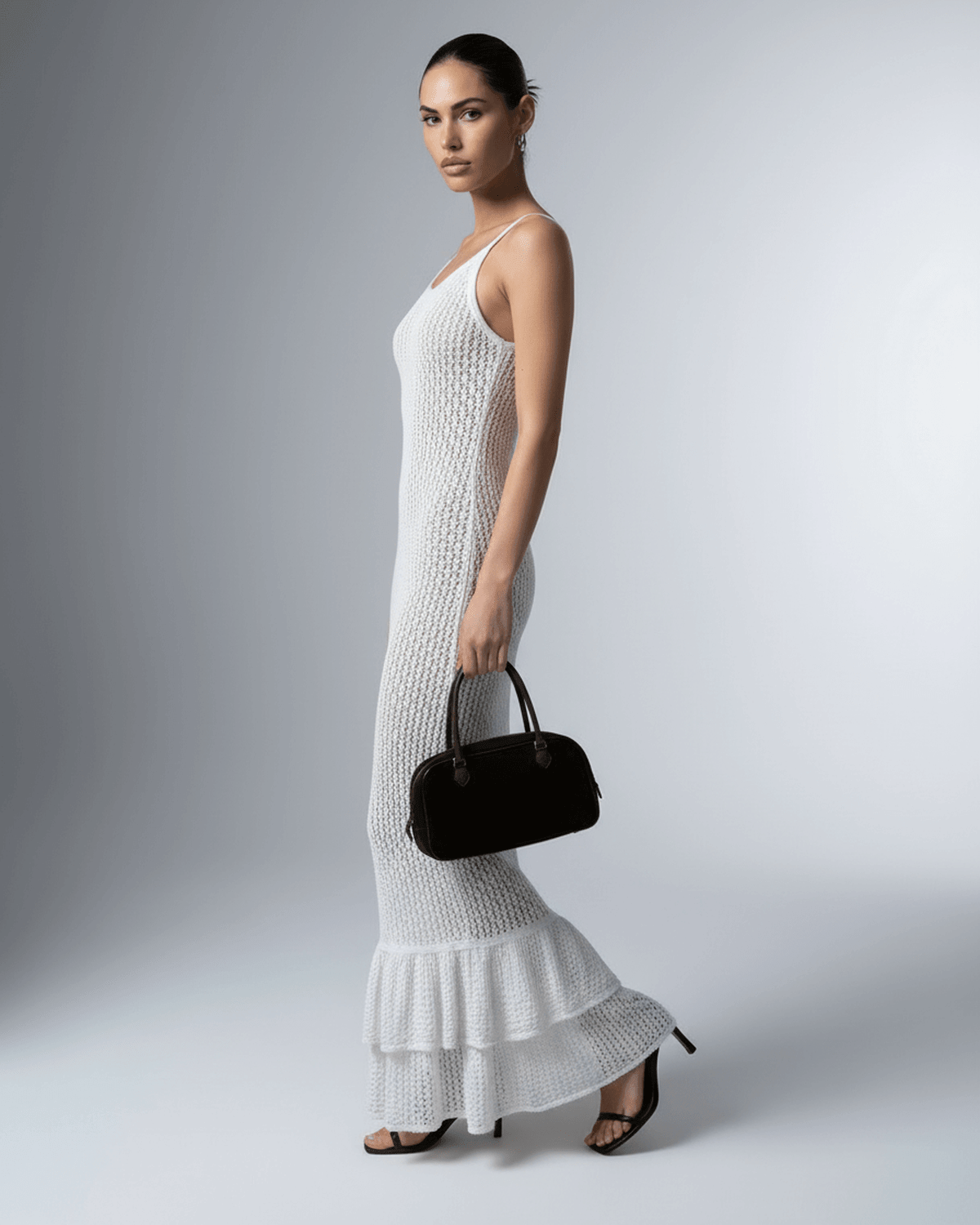 Pearl Maxi Dress by Lauven, a white hollow-out bodycon dress with a flattering silhouette.