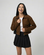 Sahara Jacket by Lauven – Women’s brown jacket with polo collar styled with a black pleated skirt.