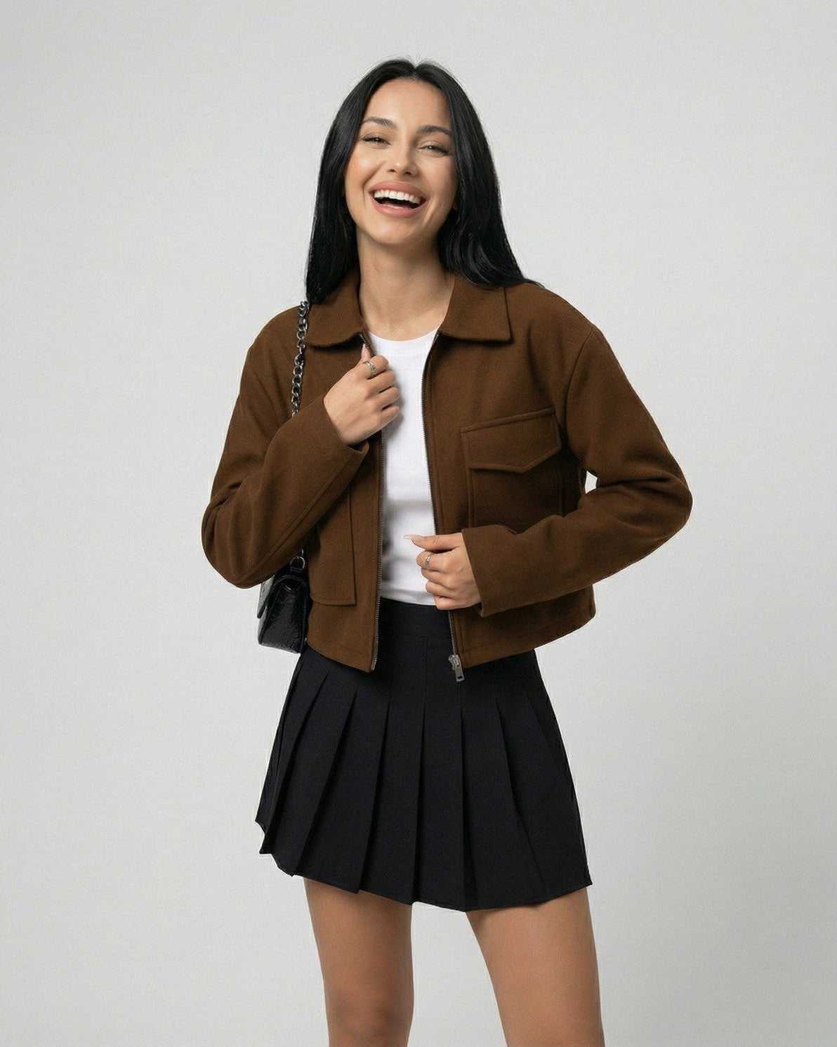 Sahara Jacket by Lauven – Women’s brown jacket with polo collar styled with a black pleated skirt.