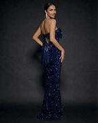 Lauven Sapphire Maxi Dress in sequin with strapless design and bold satin bow, showcasing elegance and sophistication.