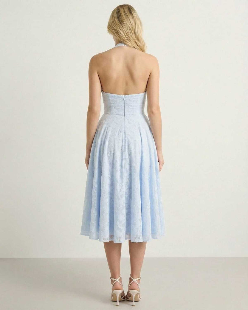 Back view of the Selene Midi Dress by Lauven showcasing its elegant A-line silhouette in a soft blue jacquard fabric.