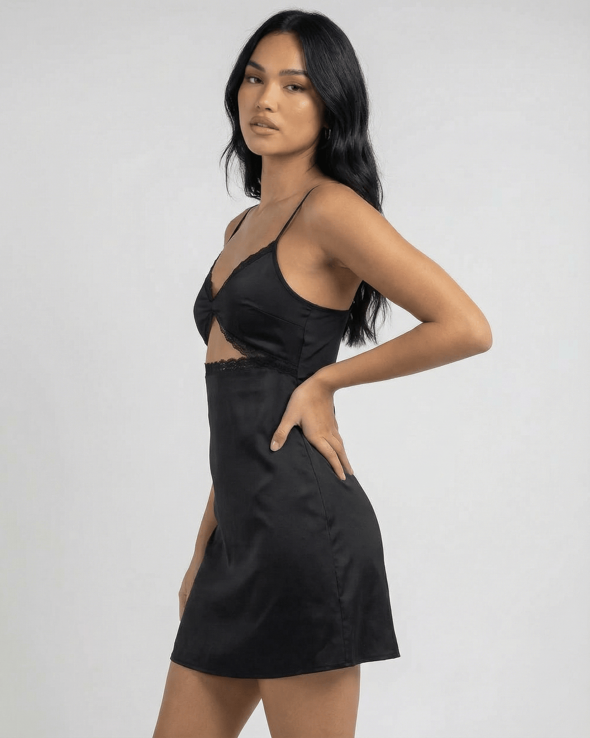 Selene Mini Dress by Lauven featuring lace trim and spaghetti straps on a model in profile.