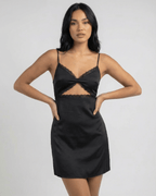 Selene Mini Dress by Lauven, featuring lace trim and spaghetti straps, in black satin-like fabric.