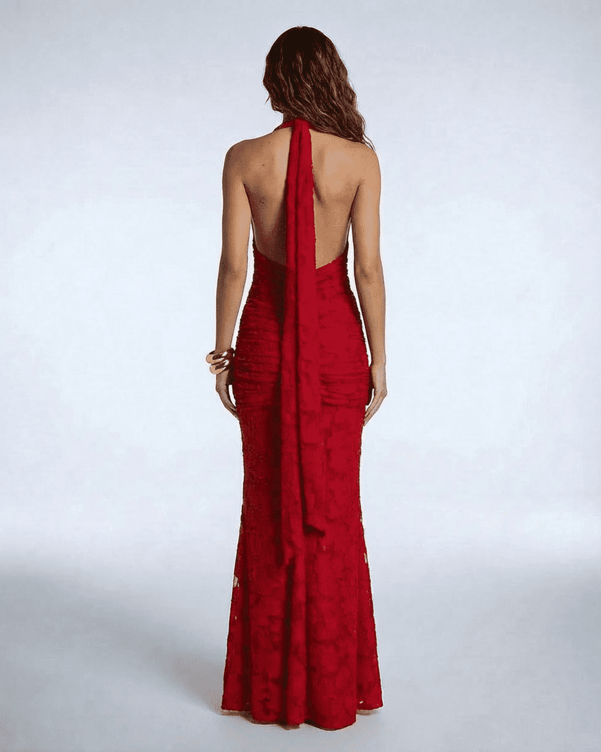 Back view of the Seraphina Maxi Dress by Lauven, showcasing its deep V-neck and dramatic ribbon tie detail.