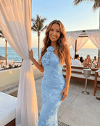 Serena Maxi Dress by Lauven, light blue halter neck with 3D floral details, perfect for summer elegance.