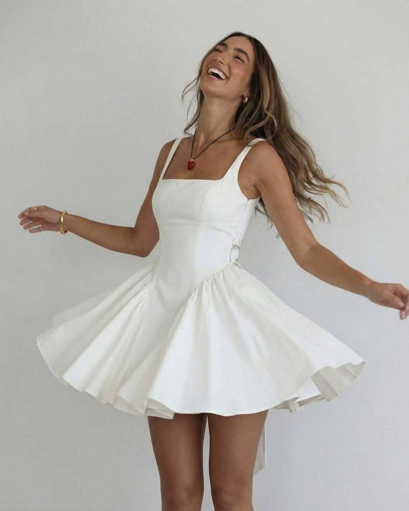 Serena Mini Dress by Lauven, elegant white square collar camisole dress worn by model, showcasing joyful style.