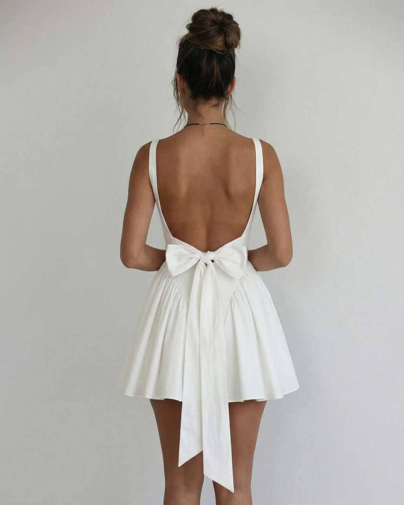 Lauven Serena Mini Dress showcases an elegant white back with a bow detail and a flirty silhouette.