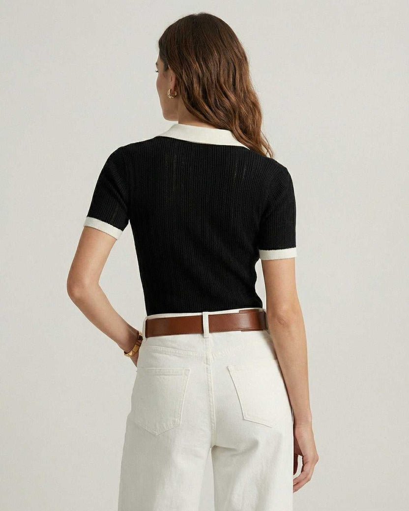 Back view of woman wearing Lauven Siena Polo Shirt in black cotton knit with contrast trim.