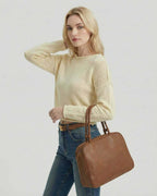 Siena Sweater by Lauven, a women's cream lightweight knit sweater styled with a brown handbag.