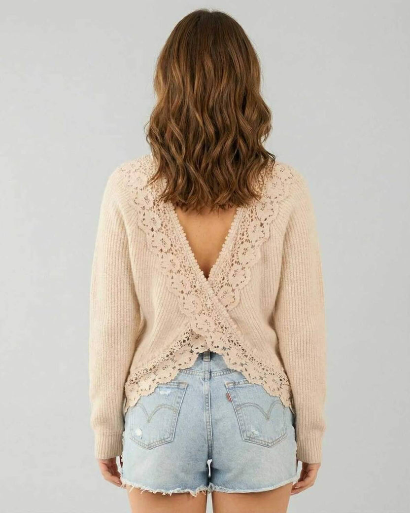 Back view of Sienna Sweater by Lauven, featuring delicate lace and long sleeves, styled with denim shorts.