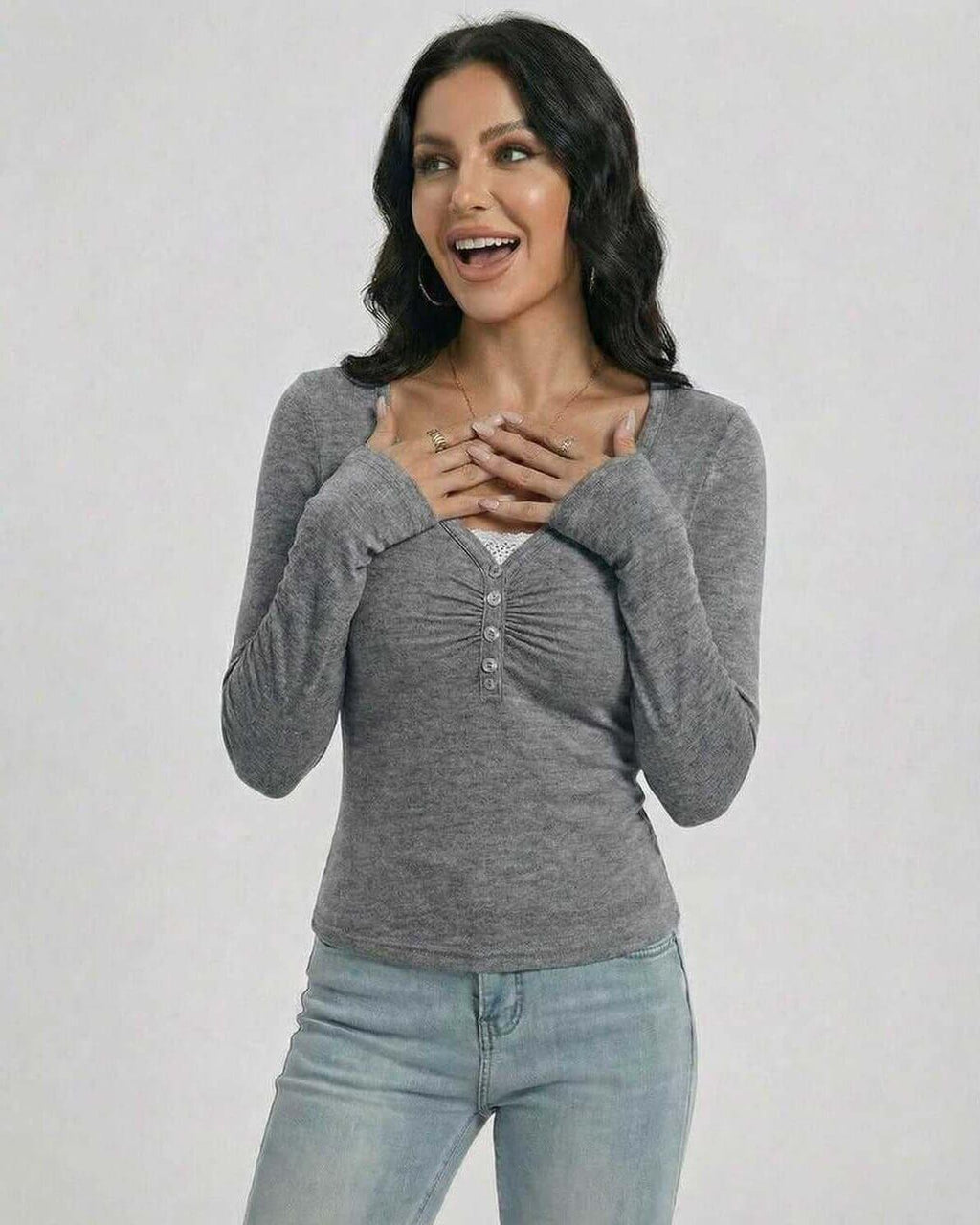 Woman wearing a Sterling Pullover by Lauven, showcasing a slim fit, V-neck design with button detailing.