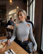 Vega Sweater by Lauven – Women’s ribbed knit turtleneck with shoulder cutouts in gray, perfect for modern winter style.