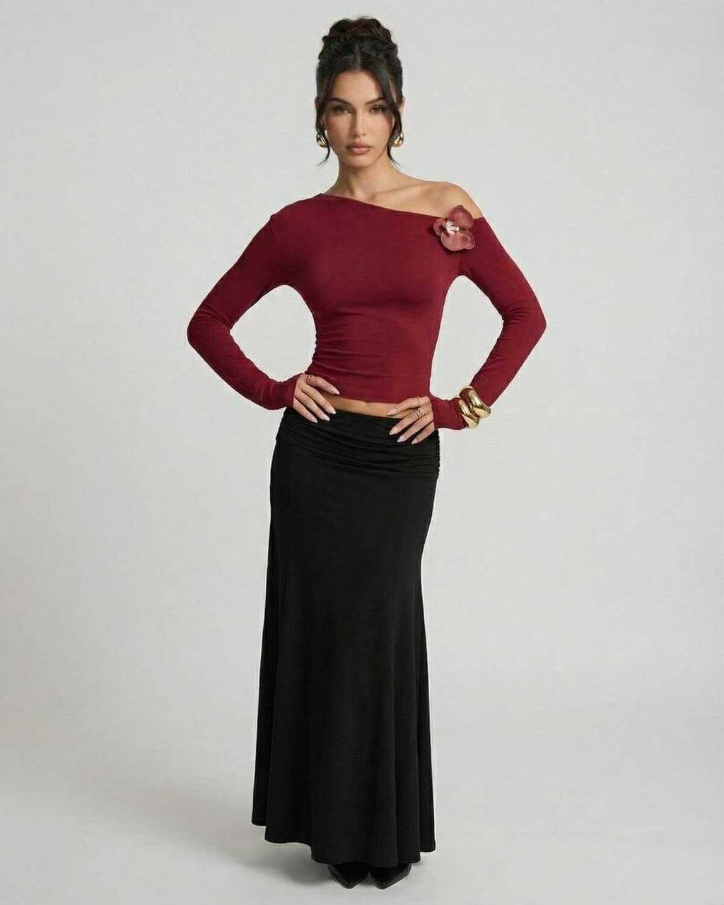 Model wearing Verona Pullover by Lauven, a women's red long sleeve slim fit pullover with asymmetric shoulder.