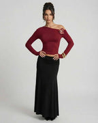 Model wearing Verona Pullover by Lauven, a women's red long sleeve slim fit pullover with asymmetric shoulder.