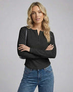 Vesper Long Sleeve top by Lauven, black long sleeve henley with button placket, styled with jeans.