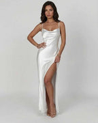 Elegant woman modeling the Celadon Maxi Dress by Lauven, featuring a luxurious satin finish and asymmetrical slit.