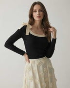Camellia Pullover by Lauven – Women’s black knit sweater with bow detail and contrast neckline.