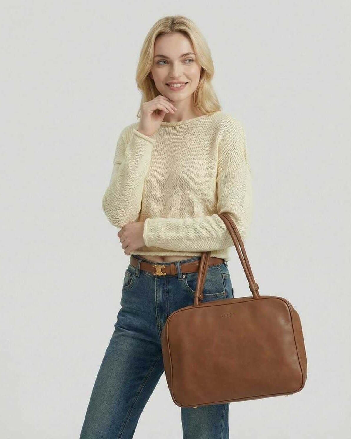 Siena Sweater by Lauven worn by a model with a brown handbag and jeans, showcasing a lightweight knit texture.