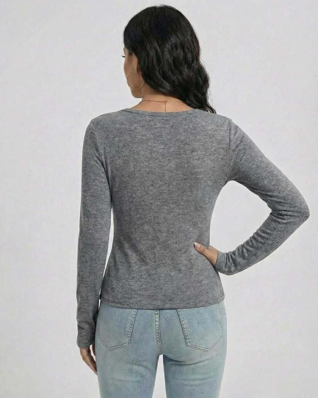 Back view of a woman wearing the Lauven Sterling Pullover in gray, showcasing its slim fit and long sleeves.
