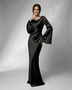 Liora Maxi Dress by Lauven featuring elegant bell sleeves and a sleek black satin silhouette.