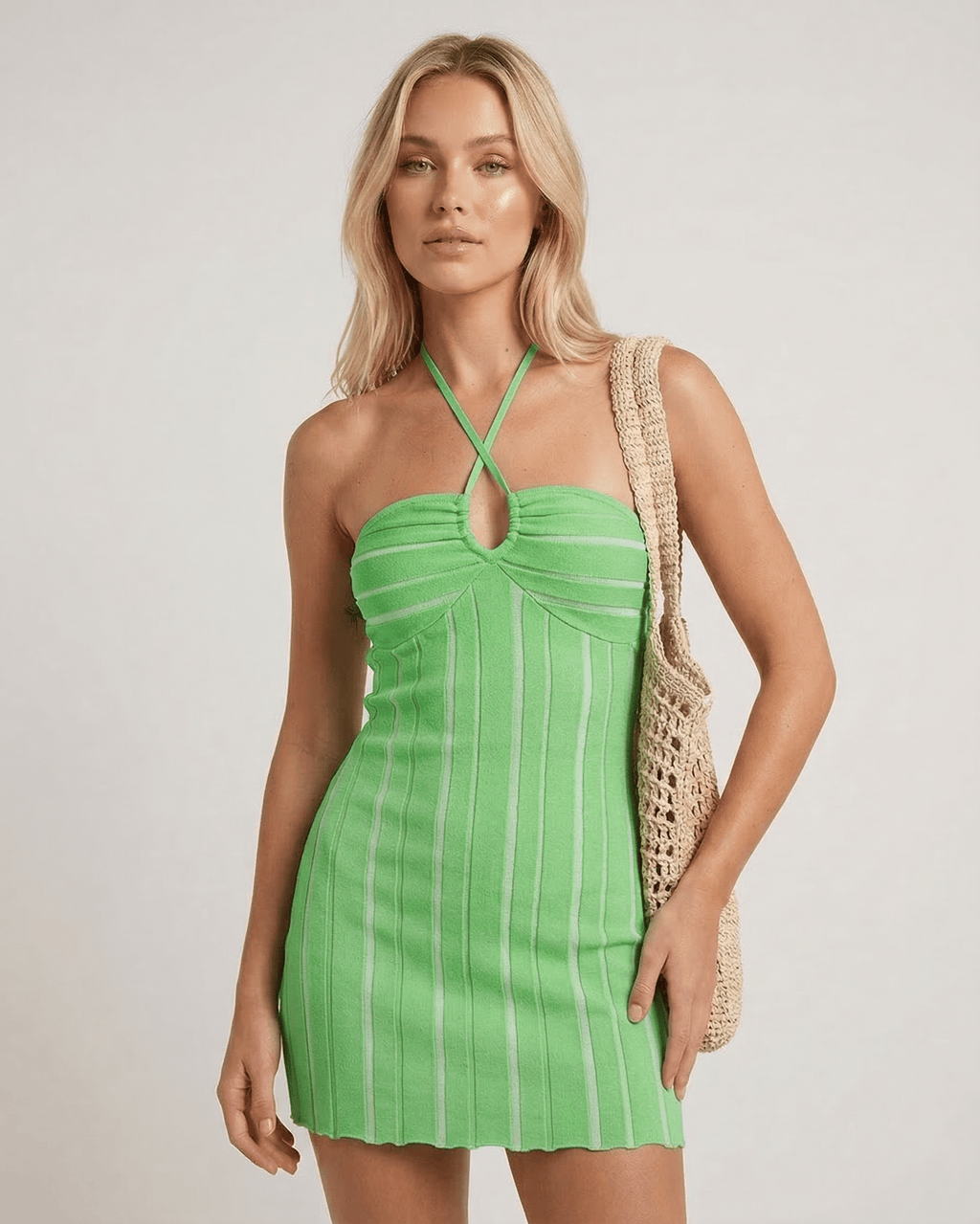 Liora Mini Dress by Lauven in vibrant green with halter neck and vertical ribbing, showcasing a flattering silhouette.