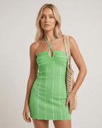 Liora Mini Dress by Lauven in vibrant green with halter neck and vertical ribbing, showcasing a flattering silhouette.