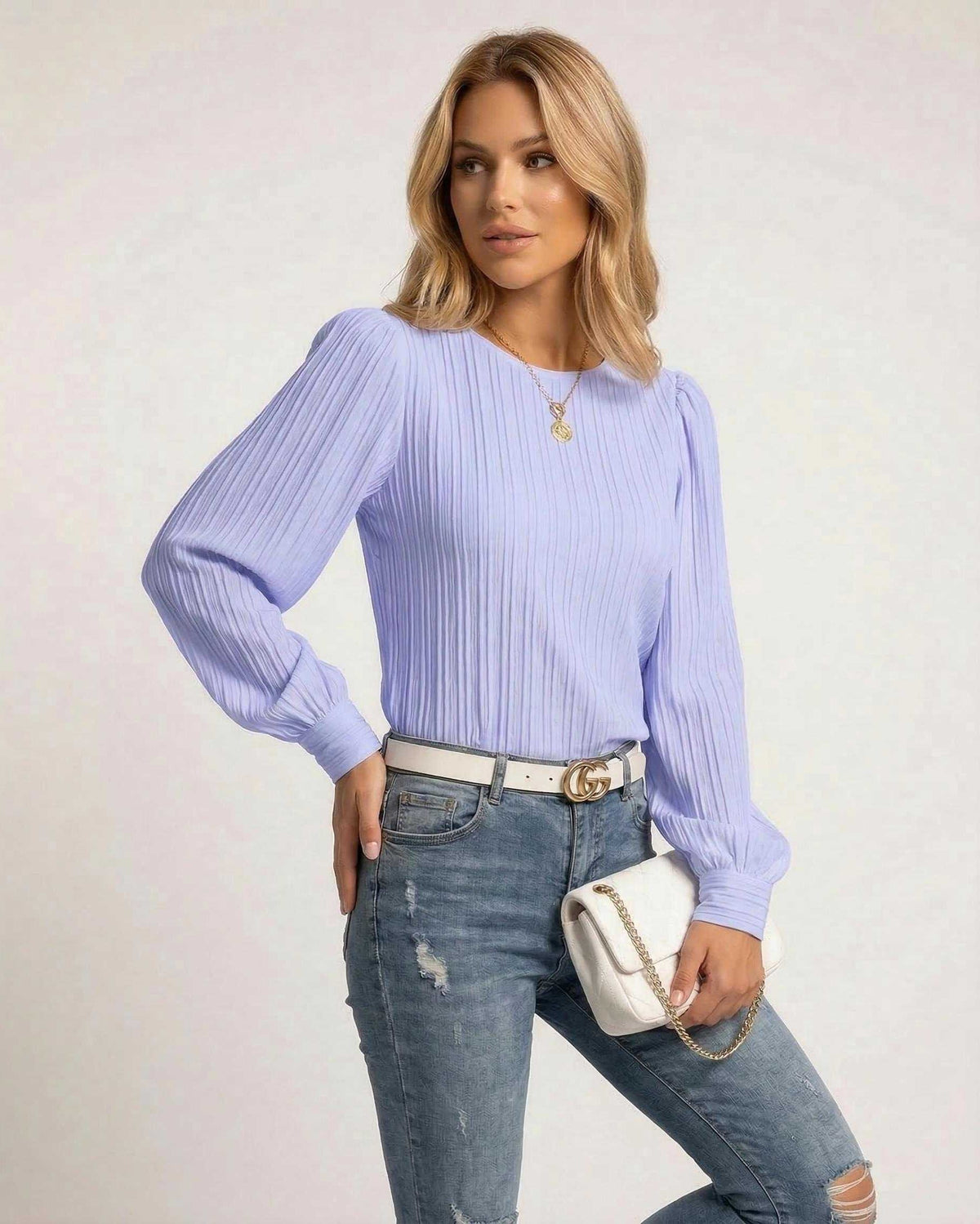 Luna Blouse by Lauven in soft lavender with pleated long sleeves, styled with jeans and a white handbag.