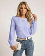 Lauven Luna Blouse in soft lavender with pleated long sleeves and fitted cuffs, styled with jeans and a chic bag.