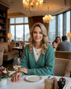 Luna Cardigan by Lauven, a woman enjoying a sophisticated dining experience in a soft knit cardigan.