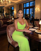 Lauven Luna Maxi Dress in vibrant lime green worn at a stylish restaurant, highlighting sleek sleeveless design.
