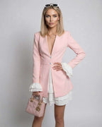 Model showcasing the Luna Mini Dress with ruffle contrast and deep V-neck, by Lauven, in blush pink color.