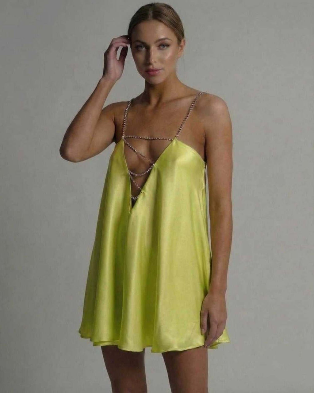 Luna Mini Dress by Lauven in vibrant chartreuse satin with elegant hollow V-neckline and flared silhouette.