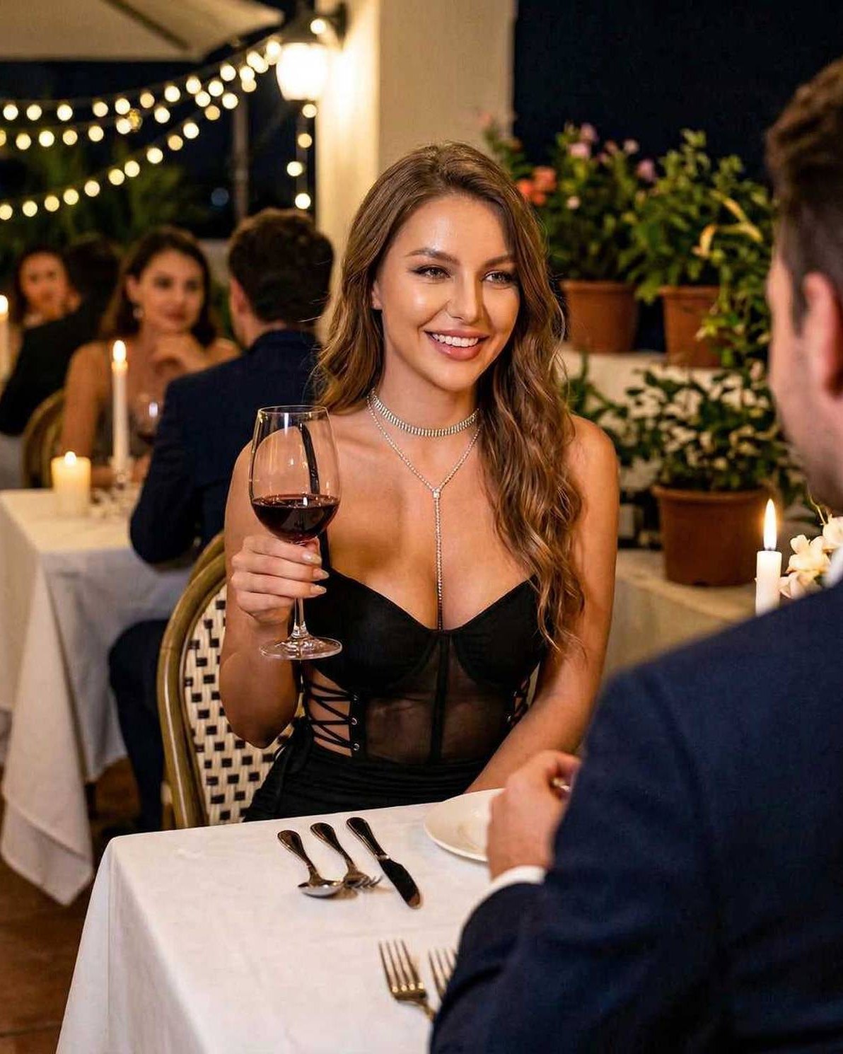 Elegant woman wearing Luna Mini Dress by Lauven, enjoying dinner and wine in a chic restaurant setting.